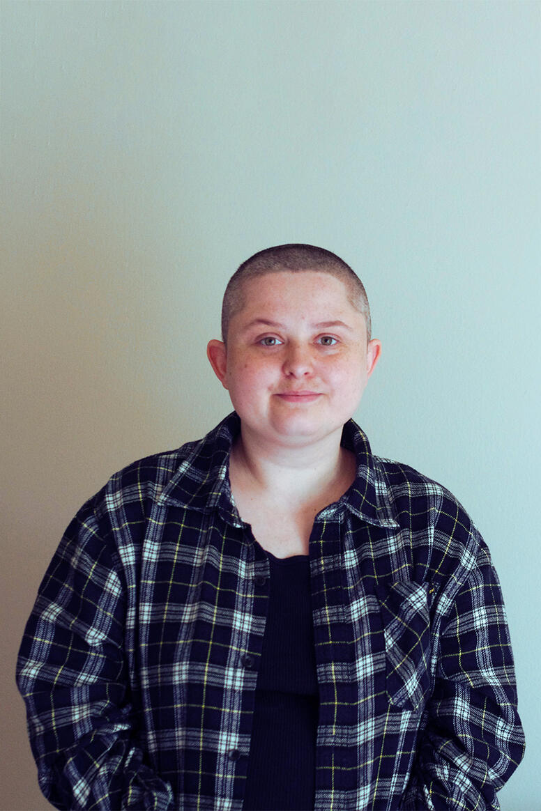a portrait of me, white chubby loser with a buzzed head wearing an open flannel over a black tank